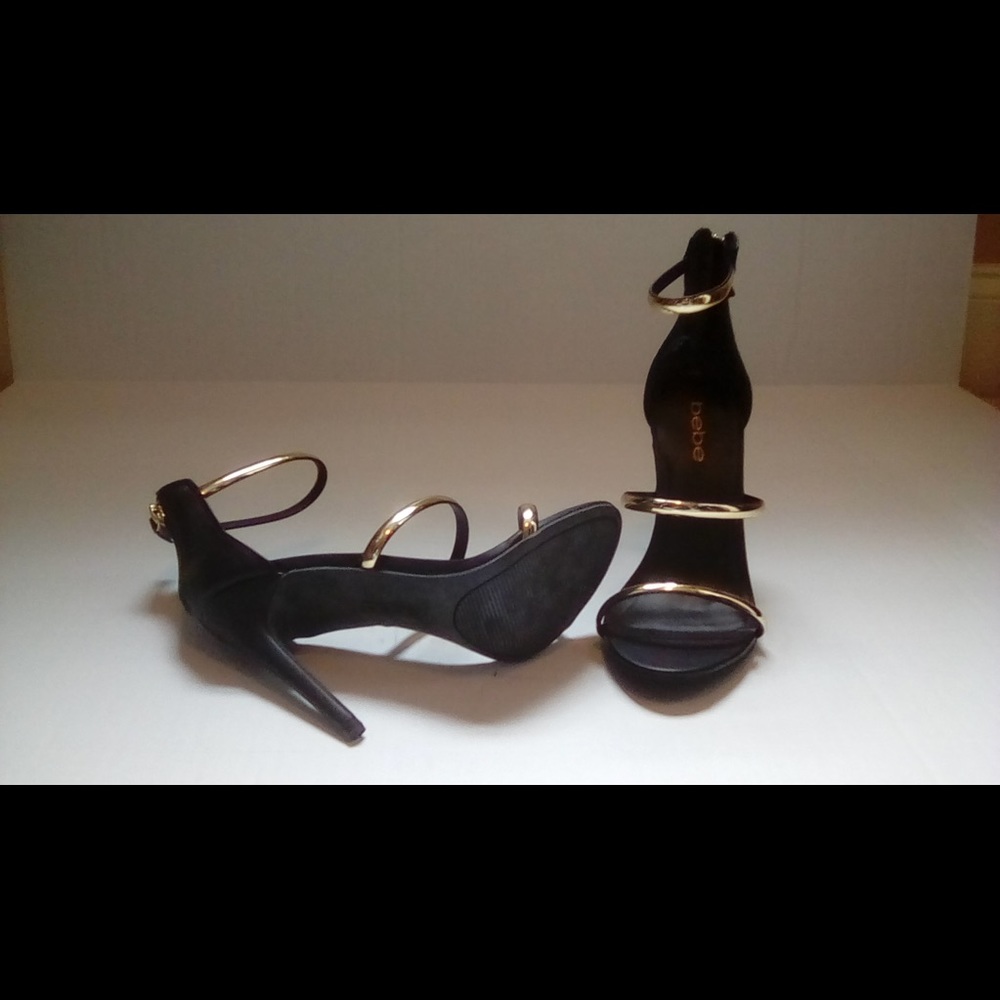 Bebe black heels with gold straps.